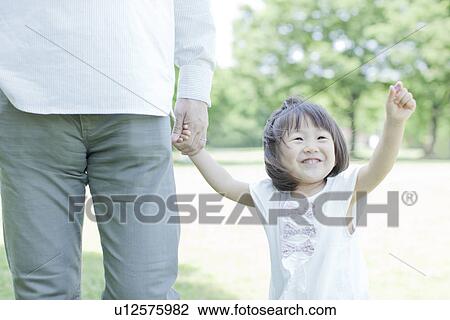 A girl holding father's hand View Large Photo Image Stock Image - A girl holding father's hand. Fotosearch
