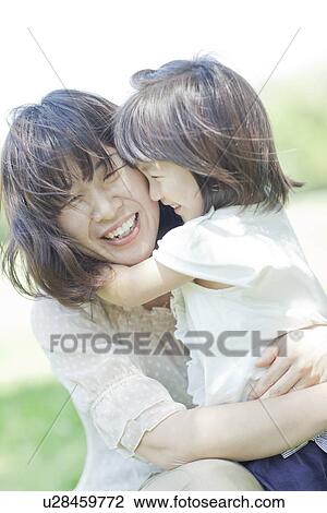 A girl holding mother View Large Photo Image Stock Image - A girl holding mother. Fotosearch