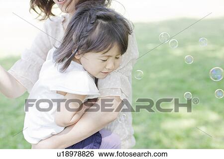 A girl holding mother View Large Photo Image Stock Photograph - A girl holding mother. Fotosearch