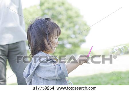 A girl playing bubbles View Large Photo Image Picture - A girl playing bubbles. Fotosearch