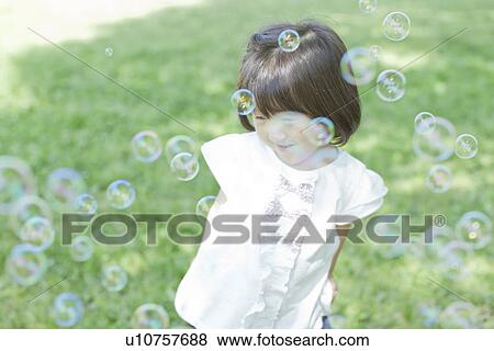 A girl playing bubbles View Large Photo Image Stock Photo - A girl playing bubbles. Fotosearch