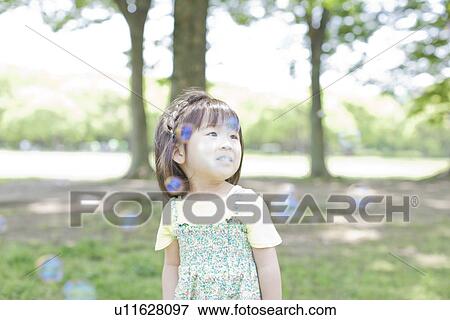 A girl playing bubbles View Large Photo Image Stock Photo - A girl playing bubbles. Fotosearch