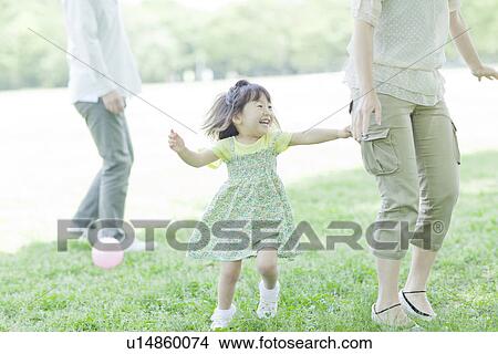 A girl playing with family View Large Photo Image Picture - A girl playing with family. Fotosearch