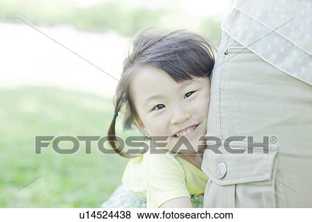 A girl playing with family View Large Photo Image Stock Photo - A girl playing with family. Fotosearch