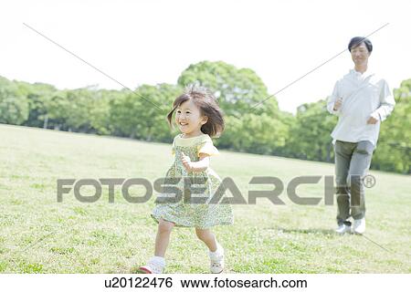 Stock Photograph - A girl running at the park. Fotosearch