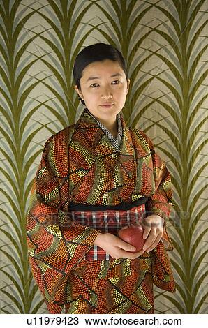 A woman holding an apple View Large Photo Image Stock Image - A woman holding an apple. Fotosearch
