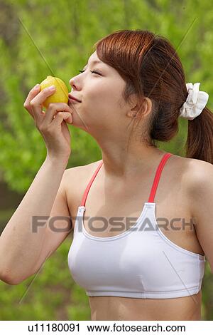 A young woman holding lemons View Large Photo Image Stock Image - A young woman holding lemons. Fotosearch