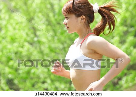 A young woman jogging View Large Photo Image Picture - A young woman jogging. Fotosearch