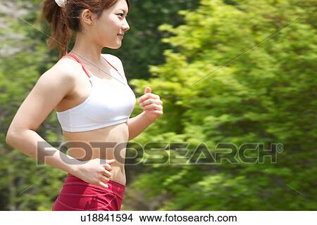 A young woman jogging View Large Photo Image Picture - A young woman jogging. Fotosearch