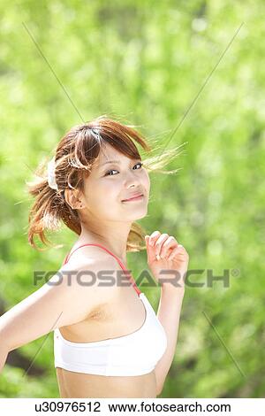 A young woman jogging View Large Photo Image Stock Image - A young woman jogging. Fotosearch