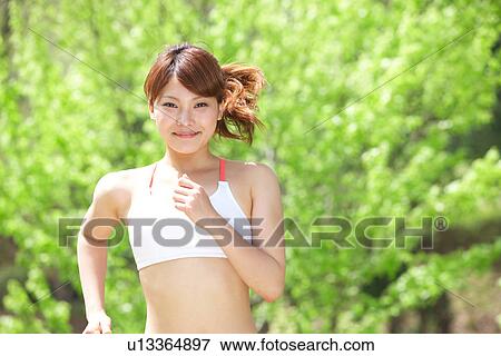 A young woman jogging View Large Photo Image Stock Photo - A young woman jogging. Fotosearch