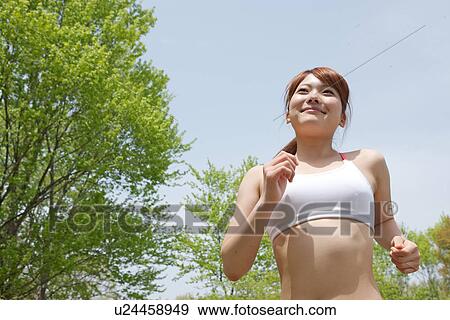 Stock Photo - A young woman jogging. Fotosearch