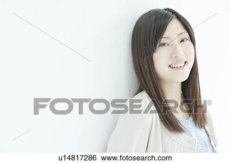 Stock Photograph - A young woman smiling. Fotosearch