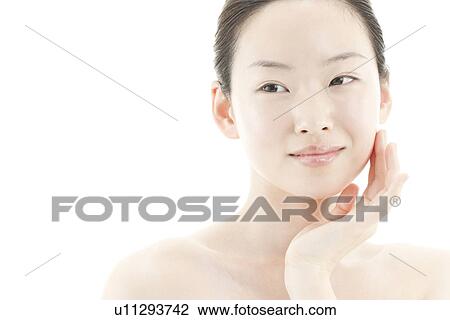 A young woman taking care of face skin View Large Photo Image Stock Image - A young woman taking care of face skin. Fotosearch