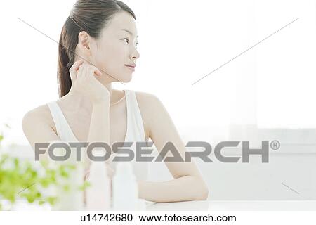 A young woman taking care of face skin View Large Photo Image Stock Image - A young woman taking care of face skin. Fotosearch