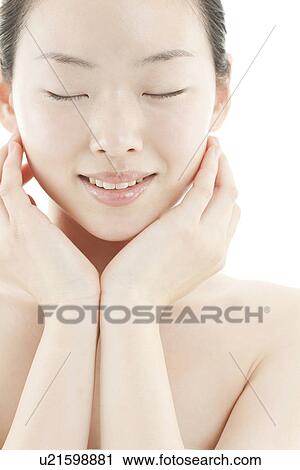A young woman taking care of face skin View Large Photo Image Stock Image - A young woman taking care of face skin. Fotosearch
