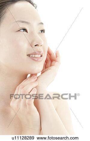 A young woman taking care of face skin View Large Photo Image Stock Photo - A young woman taking care of face skin. Fotosearch
