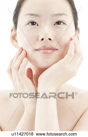 A young woman taking care of face skin View Large Photo Image Stock Photo - A young woman taking care of face skin. Fotosearch
