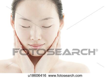 A young woman taking care of face skin View Large Photo Image Stock Photograph - A young woman taking care of face skin. Fotosearch