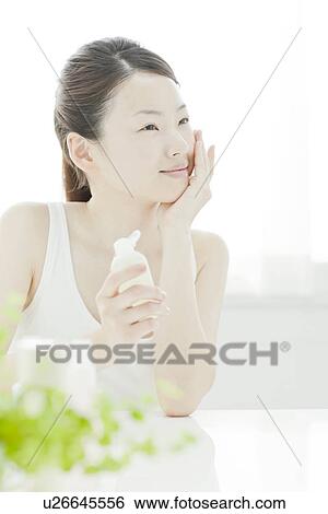 A young woman taking care of face skin View Large Photo Image Stock Photograph - A young woman taking care of face skin. Fotosearch