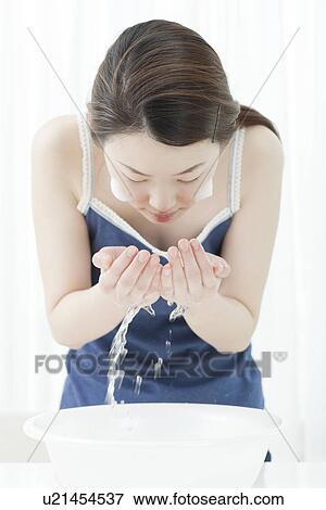 A young woman washing face View Large Photo Image Stock Photo - A young woman washing face. Fotosearch