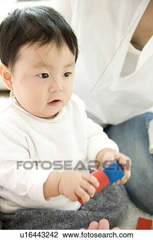 Baby boy playing with toy blocks View Large Photo Image Stock Image - Baby boy playing with toy blocks. Fotosearch