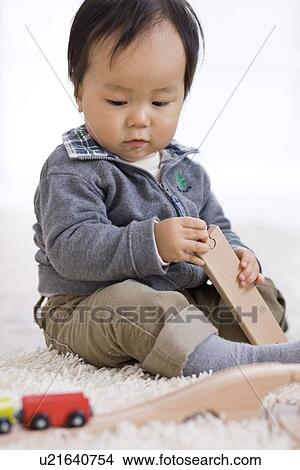 Baby playing with toy train View Large Photo Image Picture - Baby playing with toy train. Fotosearch