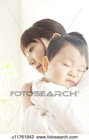 Baby sleeping in mother's arms View Large Photo Image Stock Image - Baby sleeping in mother's arms. Fotosearch