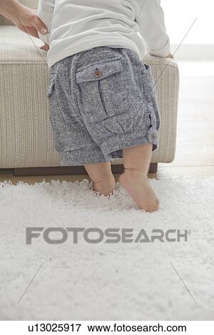 Baby Standing Against Stool View Large Photo Image Stock Photo - Baby Standing Against Stool. Fotosearch