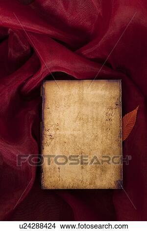 Picture - Book and a Leaf on a Cloth. Fotosearch