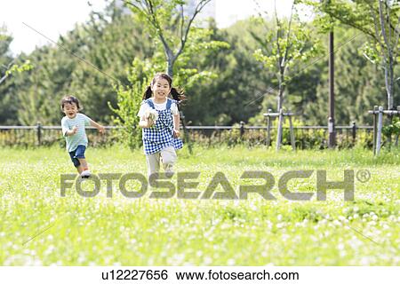 Boy and Girl Running In Field View Large Photo Image Stock Photograph - Boy and Girl Running In Field. Fotosearch
