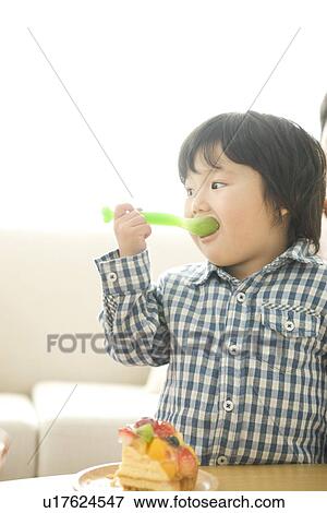 Boy eating cake View Large Photo Image Stock Photo - Boy eating cake. Fotosearch