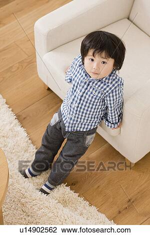 Boy in living room View Large Photo Image Stock Image - Boy in living room. Fotosearch