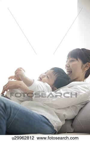 Boy on Mother's Lap View Large Photo Image Stock Image - Boy on Mother's Lap. Fotosearch