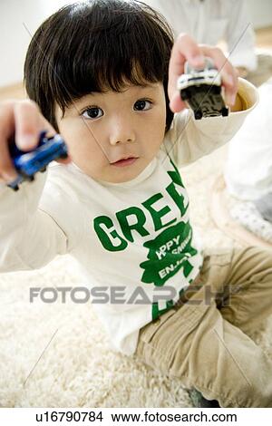 Boy playing with toy cars View Large Photo Image Picture - Boy playing with toy cars. Fotosearch