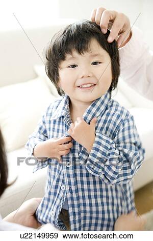 Stock Photo - Boy putting on shirt. Fotosearch