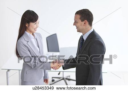 Stock Photo - Businessman and Businesswoman Shaking Hands. Fotosearch