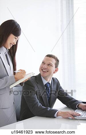 Businessman and Businesswoman Working Together View Large Photo Image Stock Image - Businessman and Businesswoman Working Together. Fotosearch