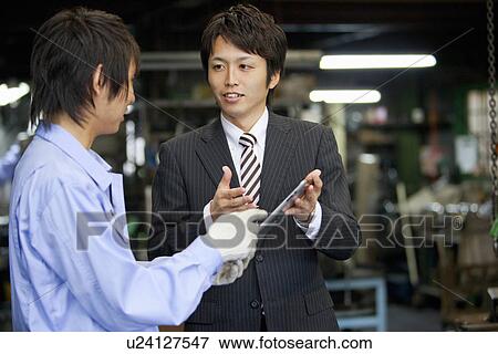 Businessman and Manual Worker Looking at Digital Tablet View Large Photo Image Stock Photo - Businessman and Manual Worker Looking at Digital Tablet. Fotosearch