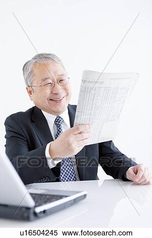 Businessman at Desk Reading Paper View Large Photo Image Stock Photography - Businessman at Desk Reading Paper. Fotosearch