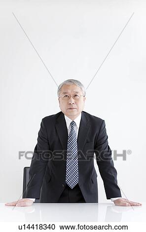 Stock Image - Businessman at Desk Standing. Fotosearch