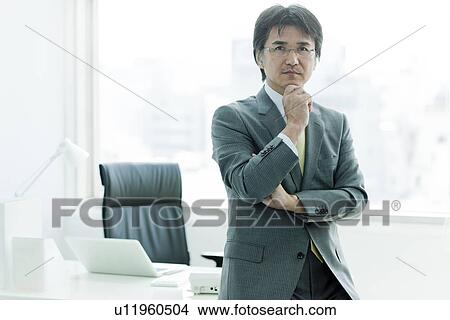 Businessman Sat On Desk, Thinking View Large Photo Image Picture - Businessman Sat On Desk, Thinking. Fotosearch