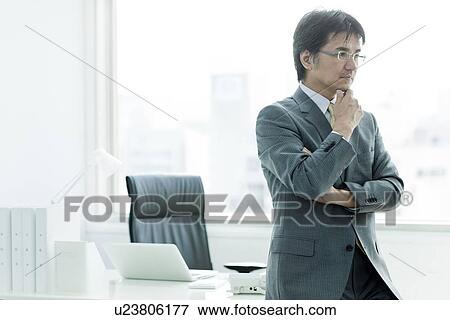 Businessman Sat On Desk, Thinking View Large Photo Image Stock Photo - Businessman Sat On Desk, Thinking. Fotosearch