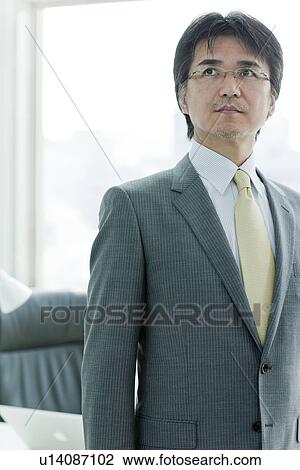 Businessman Standing In Front of Desk View Large Photo Image Stock Image - Businessman Standing In Front of Desk. Fotosearch
