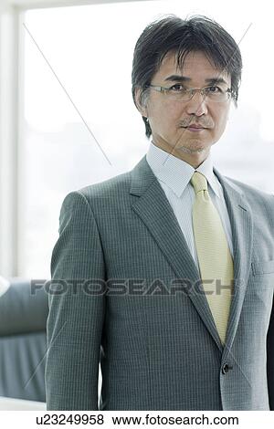 Businessman Standing In Front of Desk View Large Photo Image Stock Photo - Businessman Standing In Front of Desk. Fotosearch