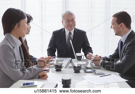 Stock Photography - Businessmen and Businesswomen In a Meeting. Fotosearch