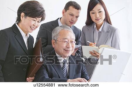 Stock Image - Businessmen and Women In a Meeting. Fotosearch