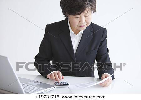 Stock Photograph - Businesswoman at Desk. Fotosearch