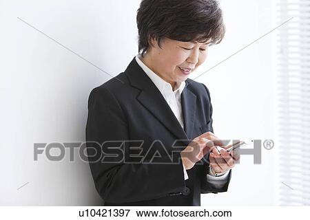 Stock Photo - Businesswoman With Smart Phone. Fotosearch