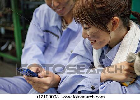 Colleagues Using Mobile Phone View Large Photo Image Stock Photo - Colleagues Using Mobile Phone. Fotosearch
